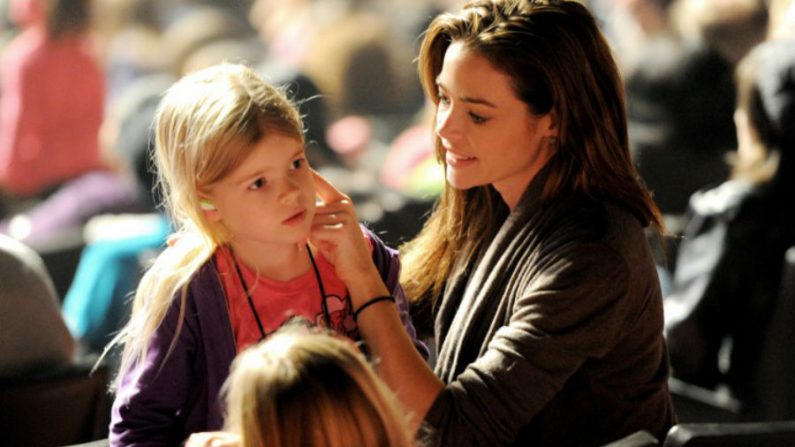 A atriz Denise Richards coloca protetores de ouvido em sua filha Sam durante o "Conserto para a Esperança", na Califórnia, EUA (Kevin Winter/Getty Images)