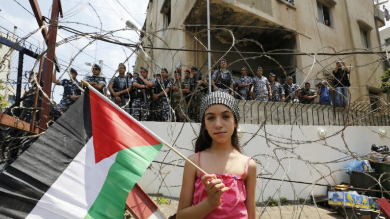 Menina segura bandeira palestina durante um protesto perto da embaixada dos EUA em Awkar, nos arredores da capital libanesa Beirute, em 20 de julho de 2014, contra a ofensiva militar israelense na Faixa de Gaza (Anwar Amro/AFP/Getty Images)