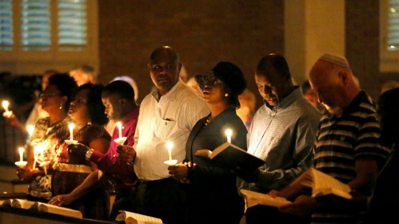 Pessoas seguram velas durante uma vigília de oração na Igreja Batista de Wilshire em memória de Thomas Eric Duncan, falecido depois de contrair o vírus Ebola em 08 de outubro de 2014 em Dallas, Texas. O Sr. Duncan faleceu de manhã (Joe Raedle/Getty Images)