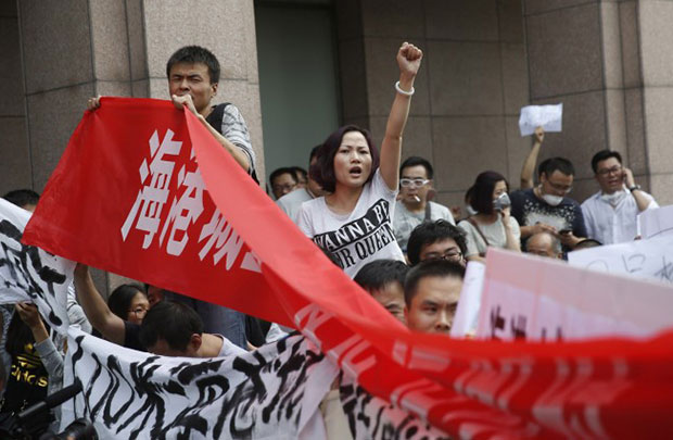 Residentes chineses protestam em frente de hotel onde autoridades realizaram conferência de imprensa em Tianjin, em 17 de agosto de 2015 (STR / AFP / Getty Images)