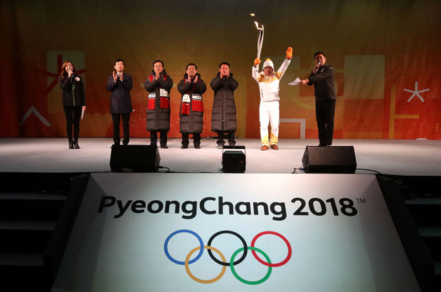 O portador da tocha, Yang Jung-Mo, detém a tocha das Olimpíadas de Inverno de Pyeongchang 2018 durante um evento da entrega da tocha da tocha olímpica em Busan, Coreia do Sul, em 4 de novembro de 2017 (Chung Sung-jun/Getty Images)