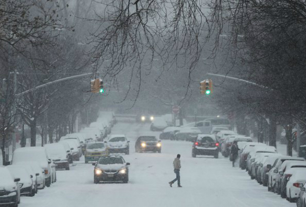 Homem caminha sobre a neve ao longo de uma rua do Brooklyn, em Nova York (Spencer Platt/Getty Images)