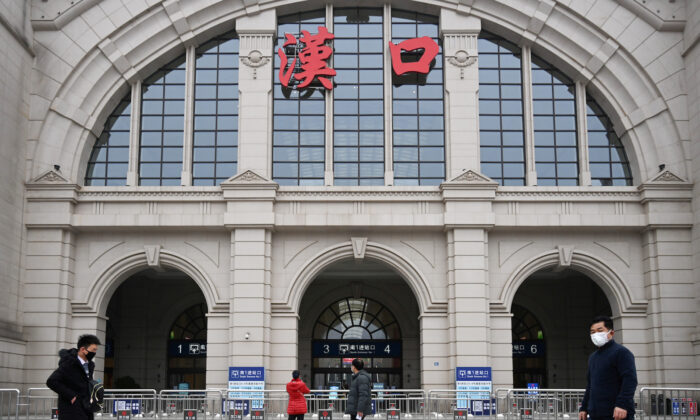 Transeuntes passam pela Estação Ferroviária Hankou fechada depois que a cidade foi interditada após o surto de um novo coronavírus em Wuhan, província de Hubei, China, em 23 de janeiro de 2020 (China Daily via Reuters)