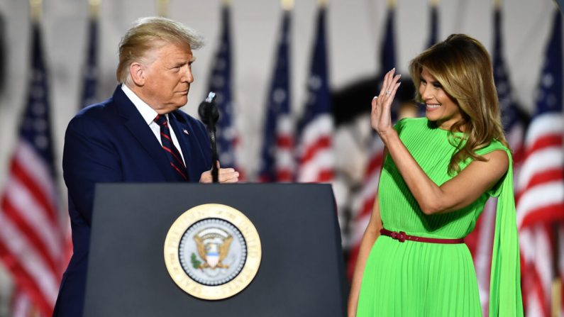 O presidente Donald Trump (à esquerda) chega com sua esposa, a primeira-dama Melania Trump para fazer seu discurso aceitando a indicação do Partido Republicano para a reeleição no último dia da Convenção Nacional Republicana do gramado sul da Casa Branca (Brendan Smialowski / AFP via Getty Images)