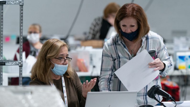 A equipe eleitoral classifica as cédulas em preparação para uma auditoria nos escritórios da Junta de Registros de Eleições e Eleições do Condado de Gwinnett em Lawrenceville, Geórgia, em 7 de novembro de 2020 (Elijah Nouvelage / Getty Images)