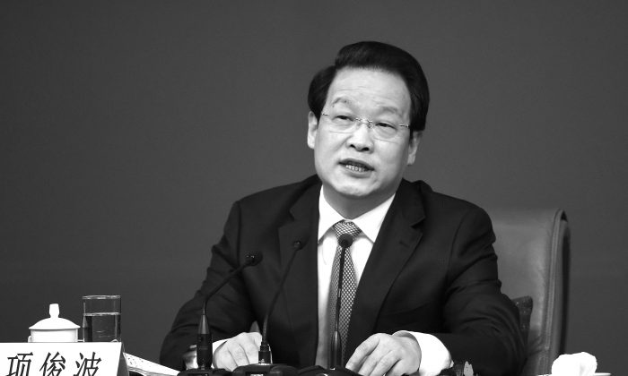 Xiang Junbo, presidente da Comissão Reguladora de Seguros da China (CIRC) no Congresso Nacional do Povo em Pequim em 12 de março de 2016 (WANG ZHAO / AFP / Getty Images)