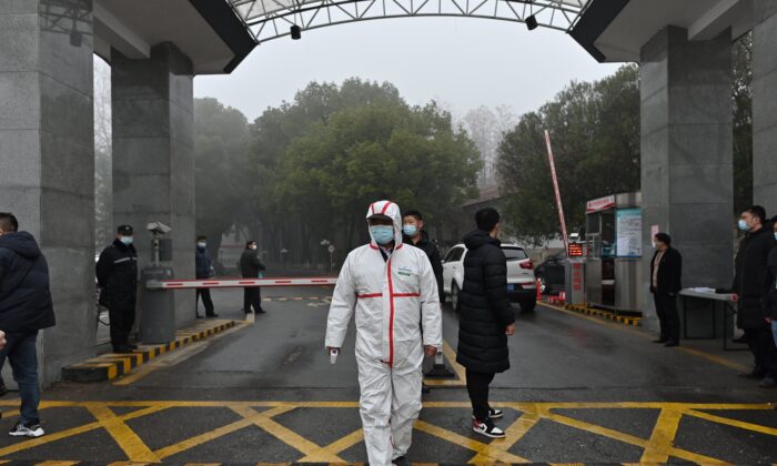 Um guarda usando equipamento de proteção na entrada do Centro Provincial de Controle e Prevenção de Doenças de Hubei, como membros da equipe da Organização Mundial da Saúde que investigava as origens do COVID-19, visitou Wuhan em 1 de fevereiro de 2021 (Foto: HECTOR RETAMAL / AFP ) (Foto de HECTOR RETAMAL / AFP via Getty Images)
