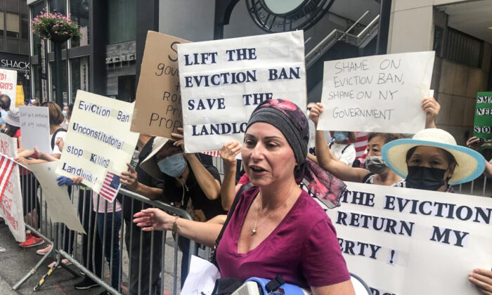 Landlord and cancer sufferer Rosanna Morey holds a megaphone while protesting in front of the New York Governor's office on Aug. 20, 2021 (Enrico Trigoso/The Epoch Times)
