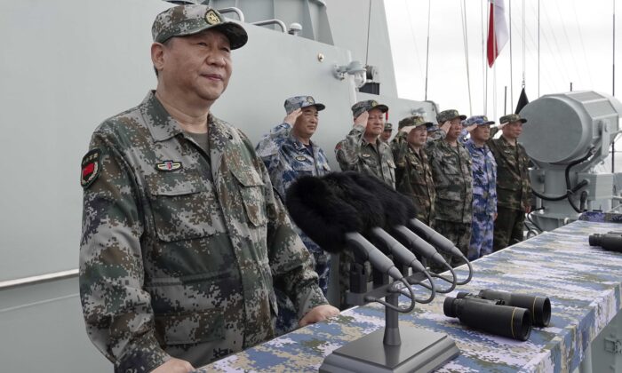 O líder chinês Xi Jinping (esquerda) se pronuncia após revisar a frota da Marinha do Exército de Libertação Popular (ELP) no Mar da China Meridional, no dia 12 de abril de 2018 (Li Gang / Xinhua via AP)
