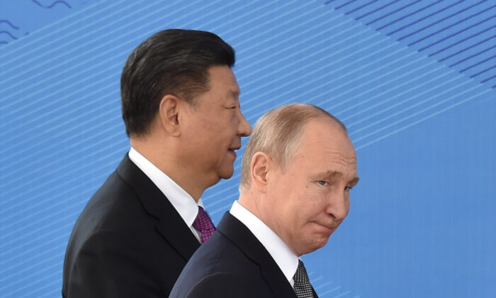 O presidente russo Vladimir Putin e o líder chinês Xi Jinping caminham enquanto participam de uma reunião do Conselho de Chefes de Estado da Organização de Cooperação de Xangai (SCO), em Bishkek, no dia 14 de junho de 2019 (Vyacheslav Oseledko/AFP via Getty Images)
