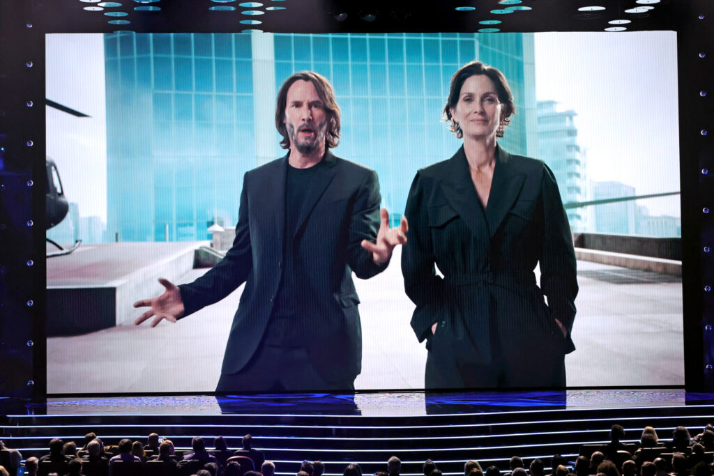 Keanu Reeves e Carrie-Anne Moss falam na tela durante o The Game Awards 2021 no Microsoft Theater em Los Angeles, Califórnia, em 09 de dezembro de 2021 (Kevin Winter/Getty Images)