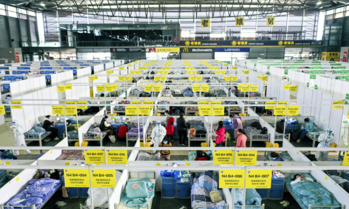 Pessoas com casos leves e sintomáticos de COVID-19 em quarentena  no Shanghai New International Expo Center, na China, em 1º de abril de 2022 (Ding Ting/Xinhua via AP)