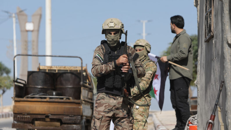 Turkey-backed Syrian fighters patrol the rebel-controlled town of Tal Abyad in Syria's northern Raqa province, on October 6, 2022. - Since the beginning of the war in Syria, Turkey has strongly opposed President Bashar al-Assad and has backed some rebel groups battling his regime. (Photo by Bakr ALKASEM / AFP) (Photo by BAKR ALKASEM/AFP via Getty Images)