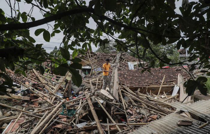 25/11/2022 - Um homem recolhe pertences de uma casa que desabou afetada pelo terremoto de magnitude 5,6 em Cianjur, na Indonésia, nesta sexta-feira (EFE/MAST IRHAM)