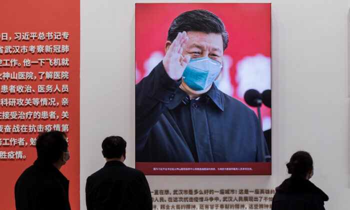 A foto do líder chinês Xi Jinping com uma máscara é exibida em um centro de convenções que antes era usado como hospital improvisado para pacientes em Wuhan, China, em 15 de janeiro de 2021. (Nicolas Asfouri/AFP via Getty Images)