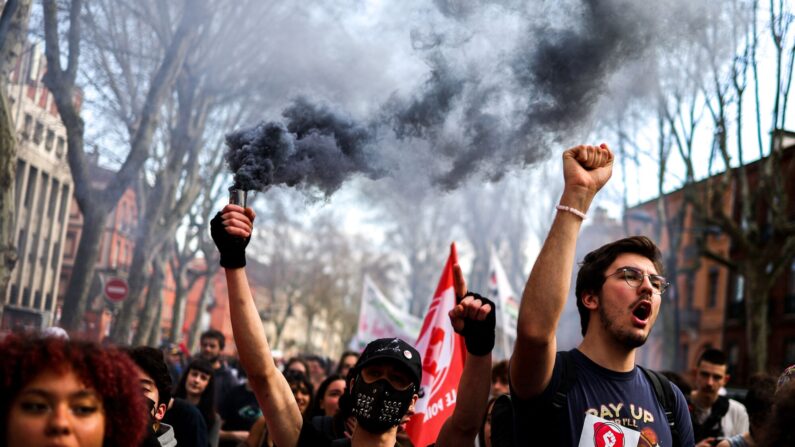 Protesters take part in a demonstration against the French government's proposed pensions reform in Toulouse, southern France, on March 9, 2023. - French unions on March 9 continued a standoff with the government over a deeply unpopular pensions overhaul, with fuel deliveries, trains and flights disrupted for a third day following mass rallies. Unions have vowed to bring the country to a standstill with strikes over the proposed changes, which include raising the minimum retirement age to 64 from 62 and increasing the number of years people have to make contributions for a full pension. (Photo by Charly TRIBALLEAU / AFP) (Photo by CHARLY TRIBALLEAU/AFP via Getty Images)