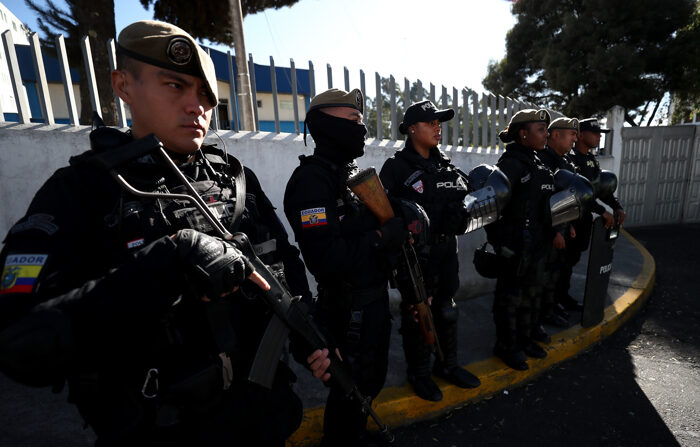 Policiais vigiam a entrada do necrotério do Serviço Nacional de Criminalística para onde foi levado o corpo do candidato presidencial Fernando Villavicencio, em Quito (EFE/José Jácome)