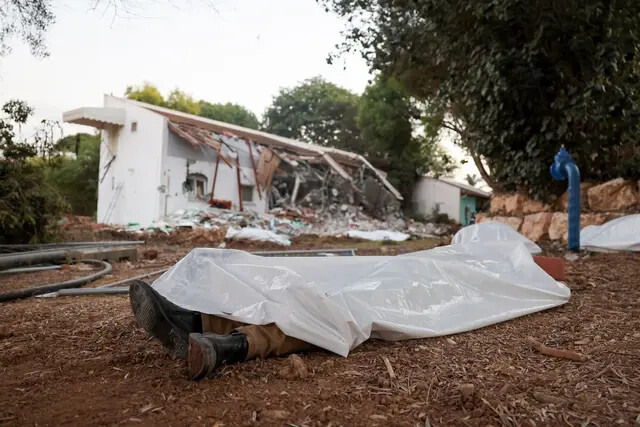 Uma foto tirada em 11 de outubro de 2023 mostra corpos cobertos no kibutz Beeri, perto da fronteira com Gaza, local de um ataque de terroristas do Hamas dias antes (Jack Guez/AFP via Getty Images)