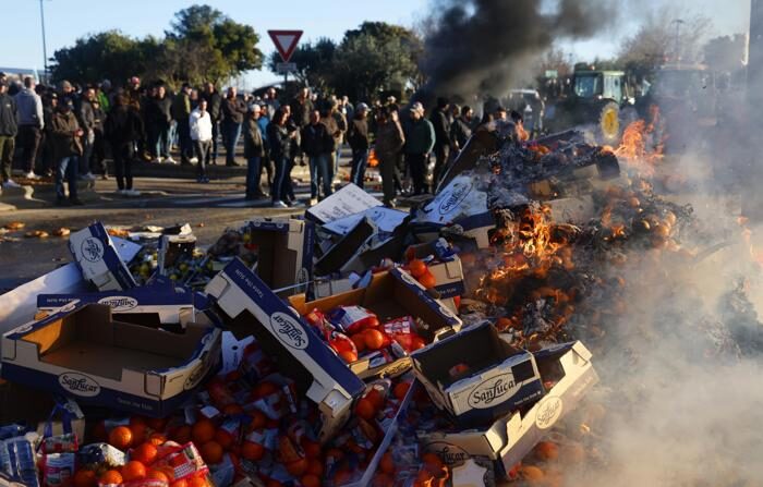Agricultores franceses queimam frutas espanholas na última quinta-feira durante uma manifestação em que bloquearam a rodovia A9 em Nîmes, no sul da França (EFE/EPA/GUILLAUME HORCAJUELO).