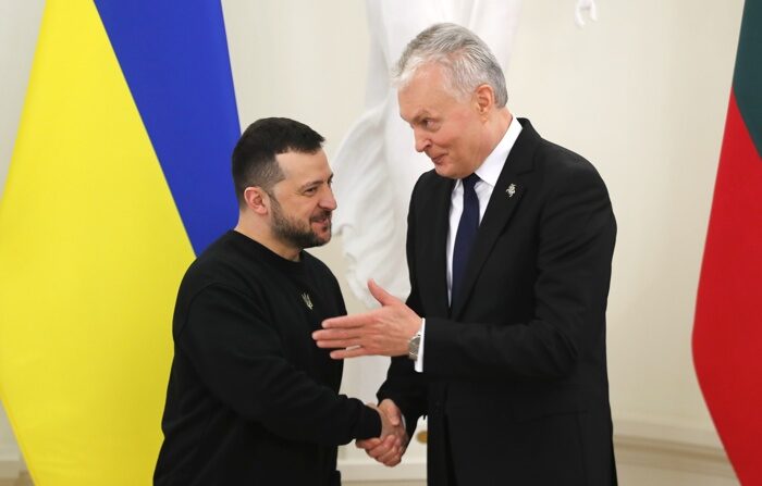 O presidente da Lituânia, Gitanas Nauseda (à direita), e o presidente da Ucrânia, Volodymir Zelenski (à esquerda), apertam as mãos durante a cerimônia de assinatura de uma declaração conjunta em Vilnius, Lituânia, em 10 de janeiro de 2024. (EFE/EPA/Tmos Kalnins)