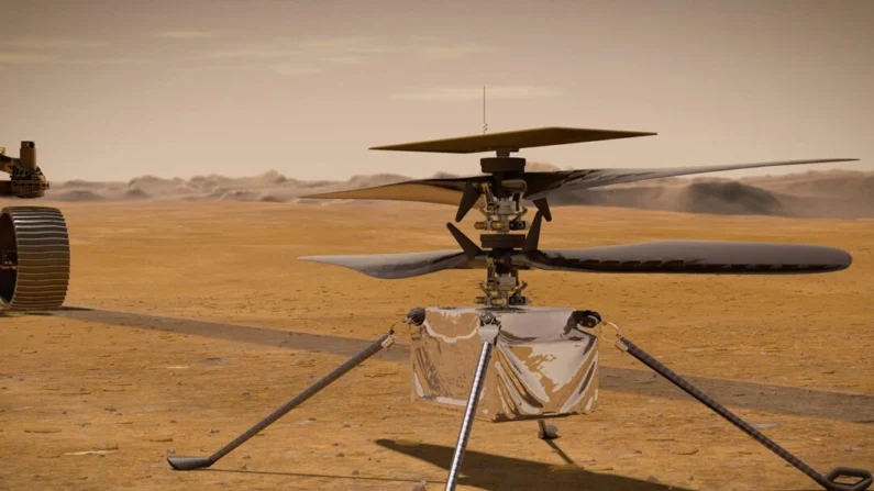 O helicóptero Ingenuity Mars da NASA está na superfície do Planeta Vermelho enquanto o rover Mars 2020 Perseverance da NASA (parcialmente visível à esquerda) se afasta. (NASA via Getty Images)
