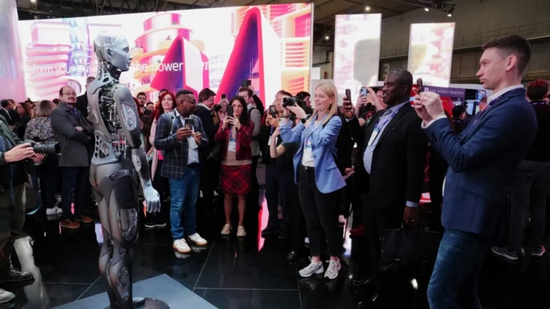 Visitantes tiram fotos de um robô durante o Mobile World Congress em Barcelona, ​​Espanha, em 26 de fevereiro de 2024 (Pau Barrena/AFP via Getty Images)
