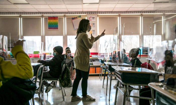 Uma professora da terceira série conversa com os alunos sobre seus medos relacionados à pandemia no primeiro dia de aprendizado presencial durante cinco dias por semana na Stark Elementary School em Stamford, Connecticut, em 10 de março de 2021 (Imagens de John Moore/Getty Images)
