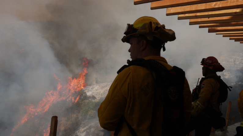 Bombeiros monitoram o incêndio de Palisades enquanto ele queima a área em 10 de janeiro de 2025 em Los Angeles, na Califórnia. O incêndio de Palisades cresceu para mais de 22.000 acres e destruiu milhares de casas. (Justin Sullivan/Getty Images)