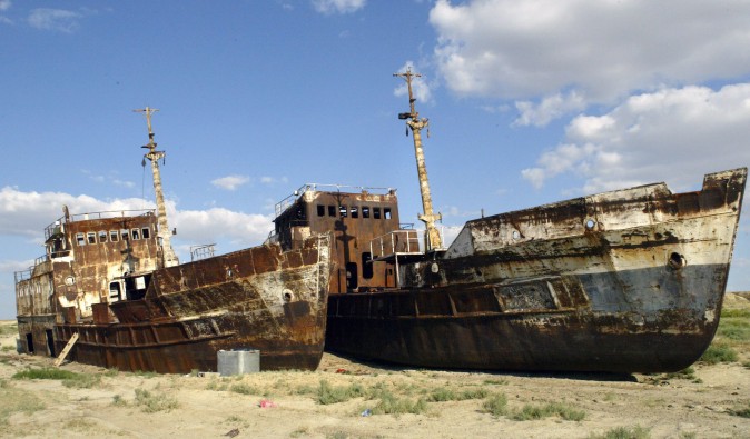 A picture taken 04 August shows rusty shipwrecks pictured at the place called "Sheeps cemetery" in Dzhambul settlement, some 64 kms from town of Aralsk. The ecological disaster on Aral Sea, which had been drying up for the past 40 years, was reached in 1987, when salted lake, which had once been the world's fourth largest, split into two unequal parts. AFP PHOTO / VYACHESLAV OSELEDKO (Photo credit should read VYACHESLAV OSELEDKO/AFP/Getty Images)