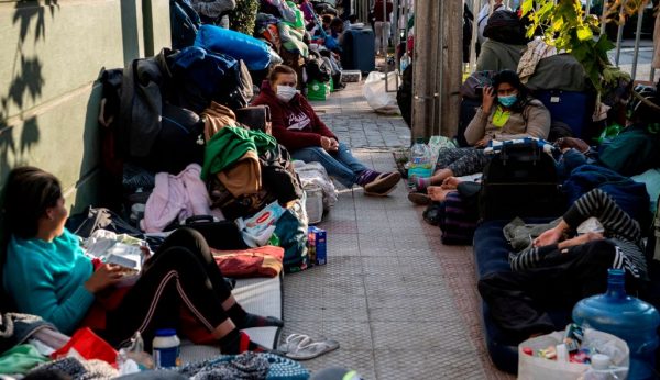 Cidadãos venezuelanos retidos permanecem fora do consulado venezuelano em Santiago (Chile) em 11 de maio de 2020, enquanto aguardam uma solução após o fechamento das fronteiras devido à pandemia do vírus do PCC (MARTIN BERNETTI / AFP via Getty Images)