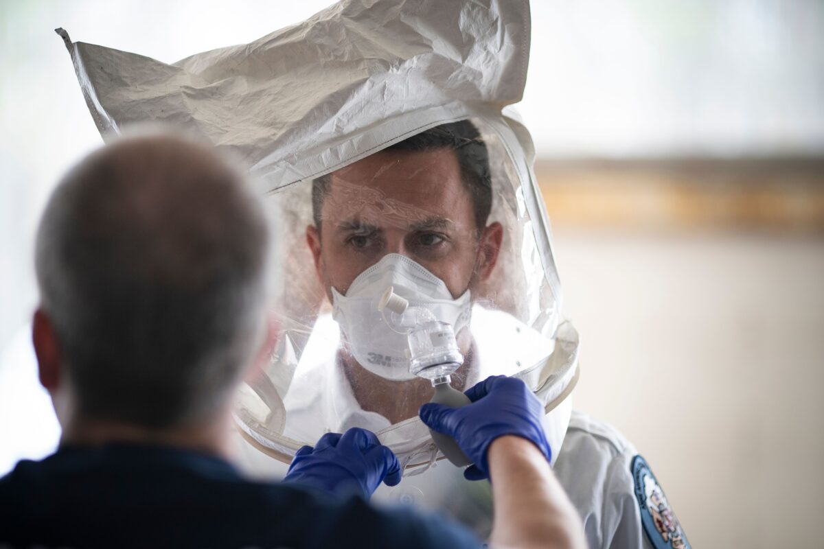 Um paramédico com o Corpo de Bombeiros do Condado de Anne Arundel testa sua máscara N-95 no início de seu turno de 24 horas em Glen Burnie, Maryland, em 9 de abril de 2020 (Alex Edelman / AFP via Getty Images)