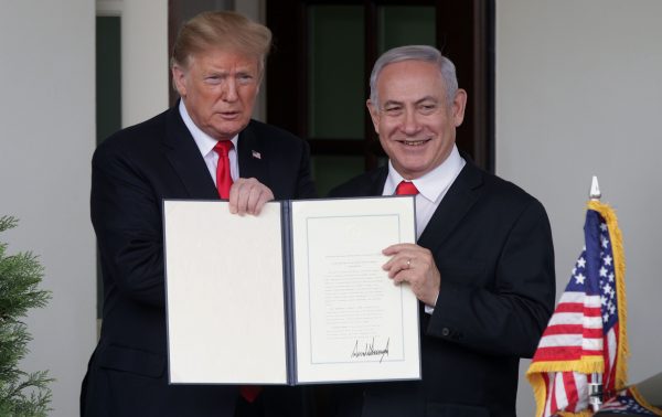 President Donald Trump (L) and Prime Minister of Israel Benjamin Netanyahu show the proclamation recognizing Israel’s sovereignty over Golan Heights after a meeting outside the West Wing of the White House