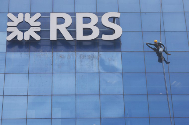 RBS, Natwest, demissões - Um trabalhador limpa o exterior das janelas ao lado do logotipo do Royal Bank of Scotland (RBS) em 8 de setembro de 2017 (Adnan Abidi/Reuters)